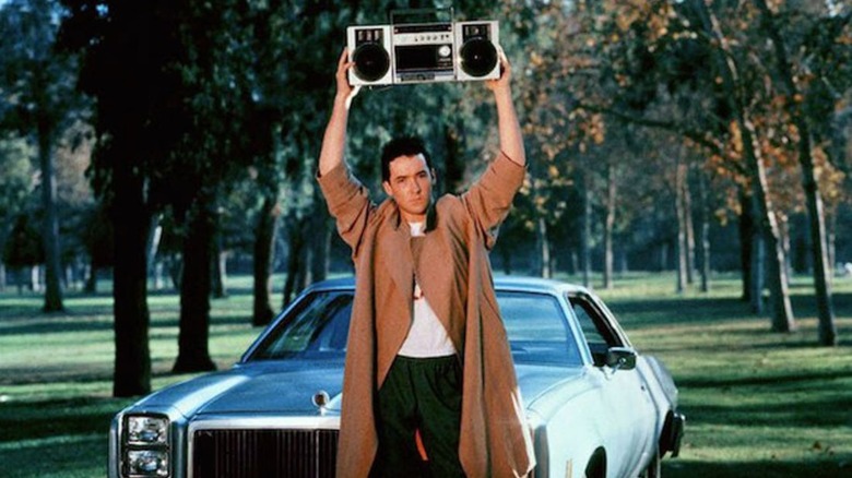 Cusack standing with boombox