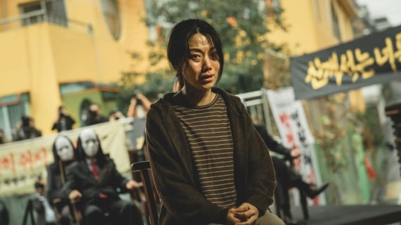 A woman awaits her fate observed by a cult in Hellbound