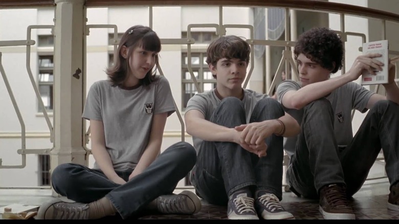 A girl and two boys sit together