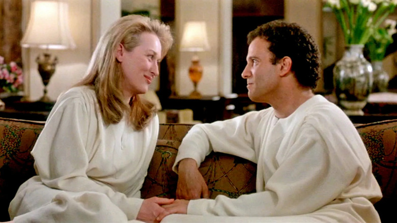 Meryl Streep as Julia and Albert Brooks as Daniel sitting on a couch in Defending Your Life