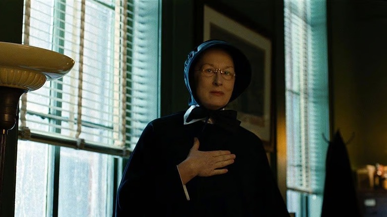 Meryl Streep as Sister Aloysius putting her hand over her chest in Doubt