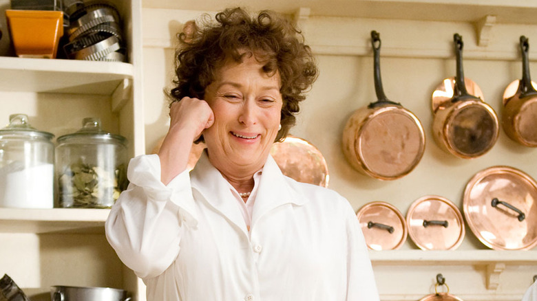 Meryl Streep as Julia Child smiling in a kitchen in Julie & Julia