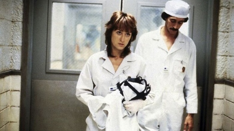 Meryl Streep as Karen Silkwood in a hallway with her protective wear in Silkwood