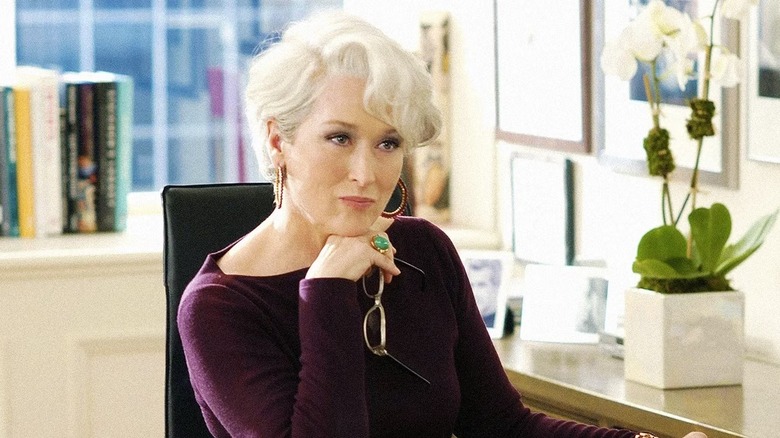 Meryl Streep as Miranda Priestly sitting at her desk in The Devil Wears Prada