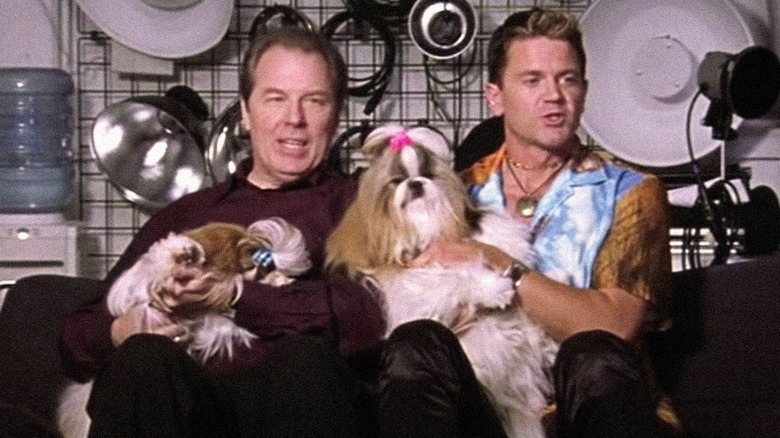 Two men sit holding their Shih Tzus in Best In Show.