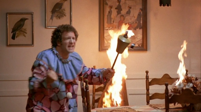 Albert Brooks in a clown suit lighting a house on fire in Read Life.