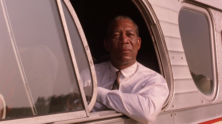 Morgan Freeman as Ellis "Red" Reddington, looking out the window of a bus in The Shawshank Redemption