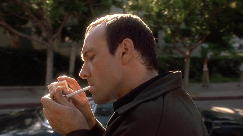 Kevin Spacey as Roger "Verbal" Kint, smoking a cigarette in The Usual Suspects