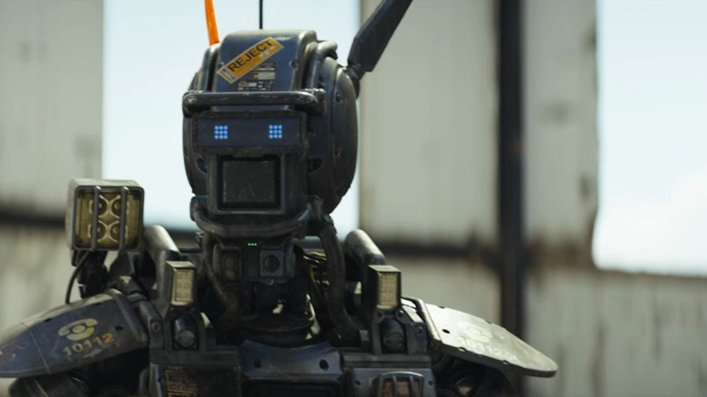 The titular Chappie (voiced by Sharlto Copley) looks to the side while outside