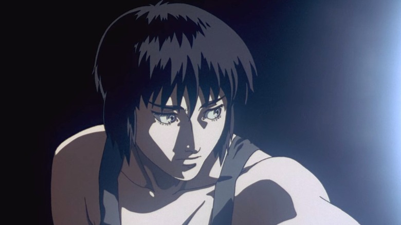 Major Motoko Kusanagi contemplates herself in a tank top in Ghost in the Shell.