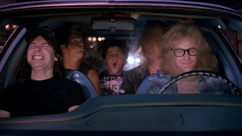 Mike Myers and Dana Carvey as Wayne and Garth headbanging in a car in Wayne's World.