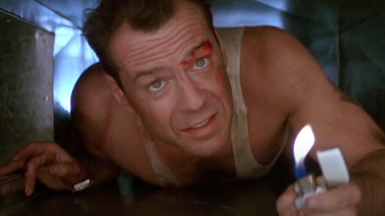 Bruce Willis as John McClane crawls through an air duct in Die Hard