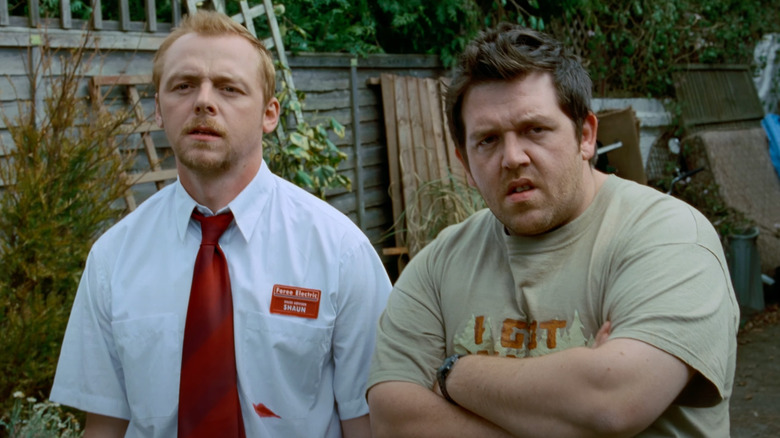 Simon Pegg as Shaun stands next to Nick Frost as Ed in Shaun of the Dead