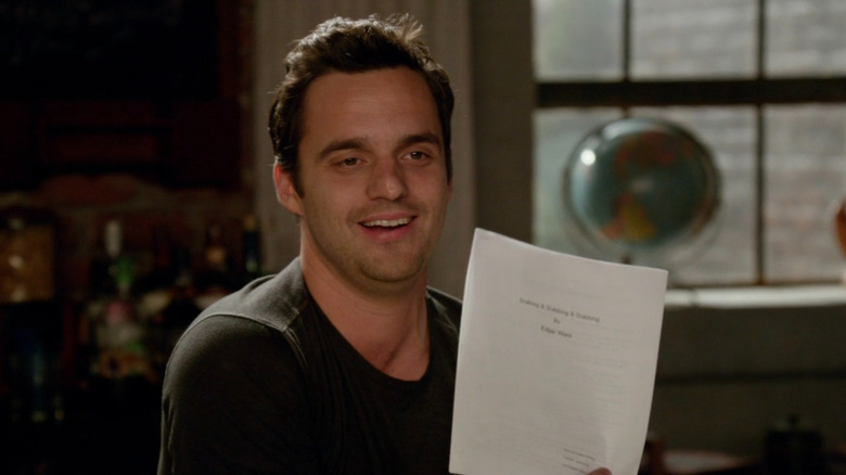 Nick Miller holding up a paper on New Girl