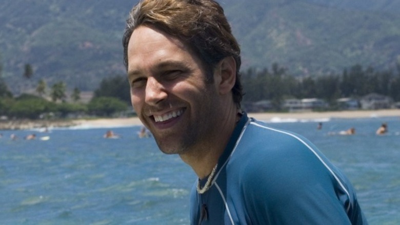 Paul Rudd surfing and smiling