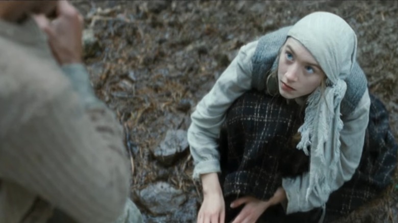 Saoirse Ronan as Irena washing a convict's feet in The Way Back