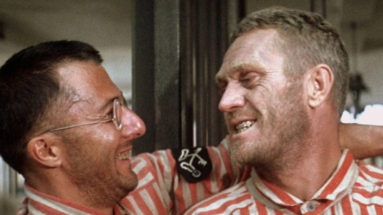 Dustin Hoffman and Steve McQueen as Dega and Papillon smiling together in Papillon