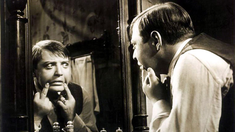 Peter Lorre as Hans Beckert making face in mirror in M