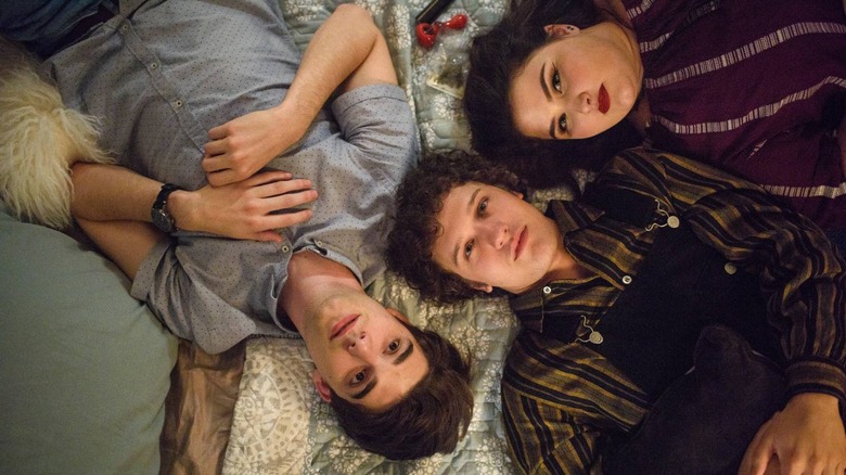 Alex, Elliot, and Claire lying on a bed in Alex Strangelove