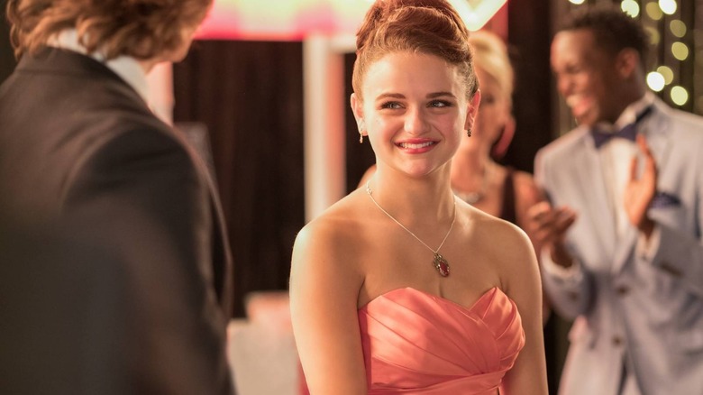 Elle Evans smiling in a pink dress in The Kissing Booth