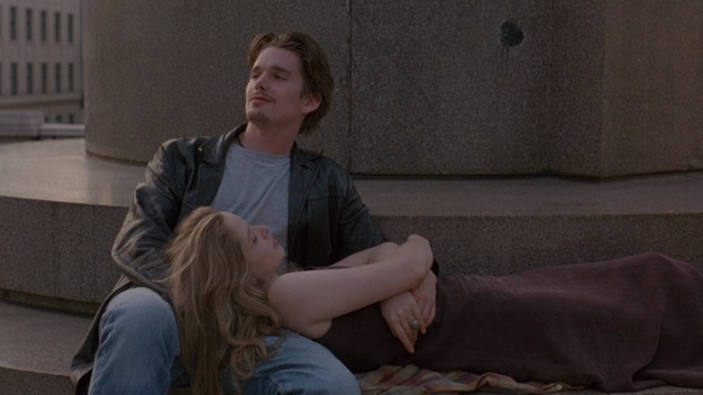 Julie Delpy as Céline lying on the lap of Ethan Hawke as Jesse in Before Sunrise