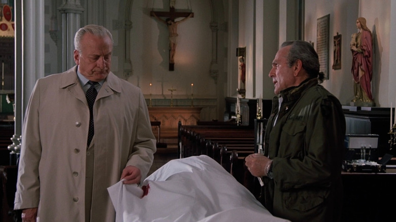 Kinderman inspecting a body at a church in The Exorcist III