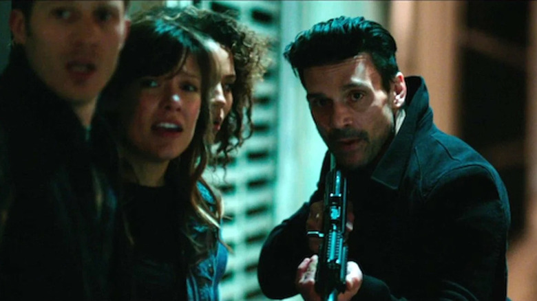 Frank Grillo prepares to protect a group of people with a gun in The Purge: Anarchy