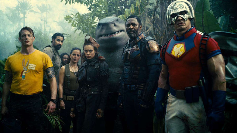 The ensemble cast of The Suicide Squad standing in the jungle