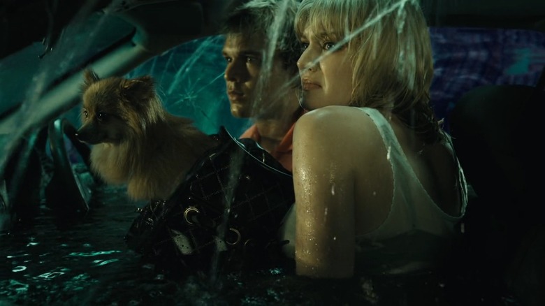 Lincoln Lewis as Kyle and Cariba Heine as Heather in BAIT, sitting in an underwater car that's sprung a leak