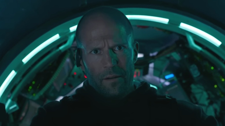 Jason Statham as Jonas Taylor in The Meg, inside a glowing teal submarine