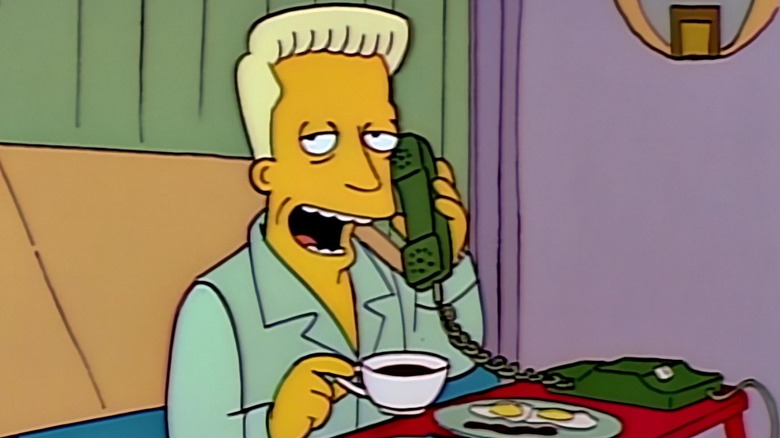 Karl on phone eating breakfast