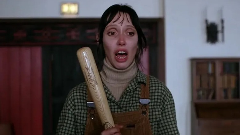 Wendy Torrance (Shelley Duvall) confronts her husband with bat in hand in The Shining