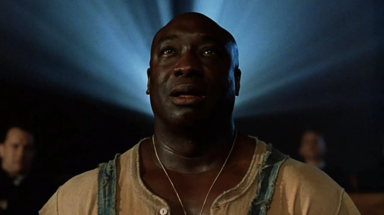 John Coffey, played by Michael Clarke Duncan, is framed like an angel as he watches a movie for the first time in The Green Mile