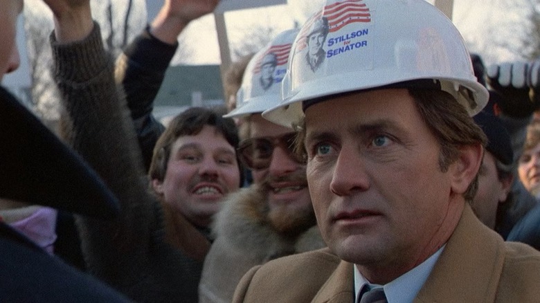 Fake blue collar grifter Greg "Trump" Stillson, played by Martin Sheen, wearing a cheap hard hat at his rally in "The Dead Zone."