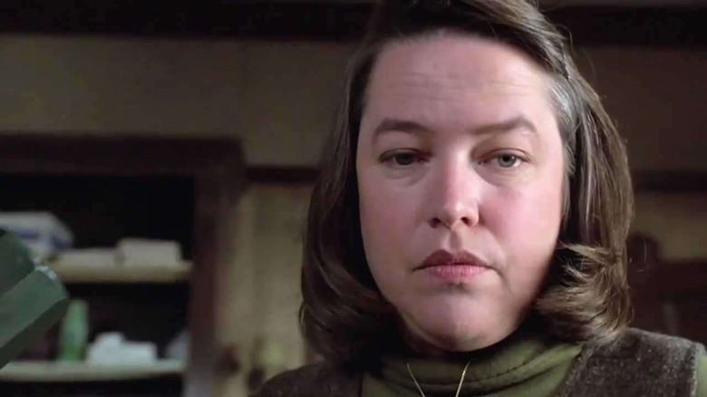 Annie Wilkes (Kathy Bates) regards her patient with emotionless malice in Misery