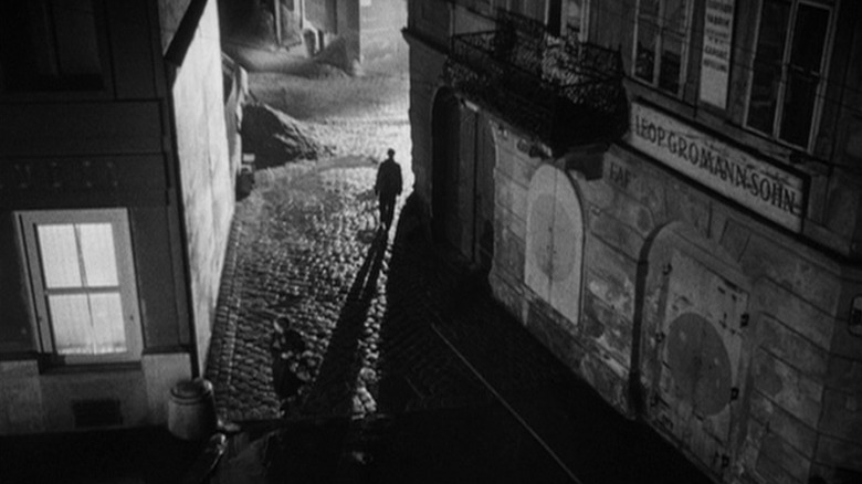 Man walking through dark Vienna streets at night in The Third Man