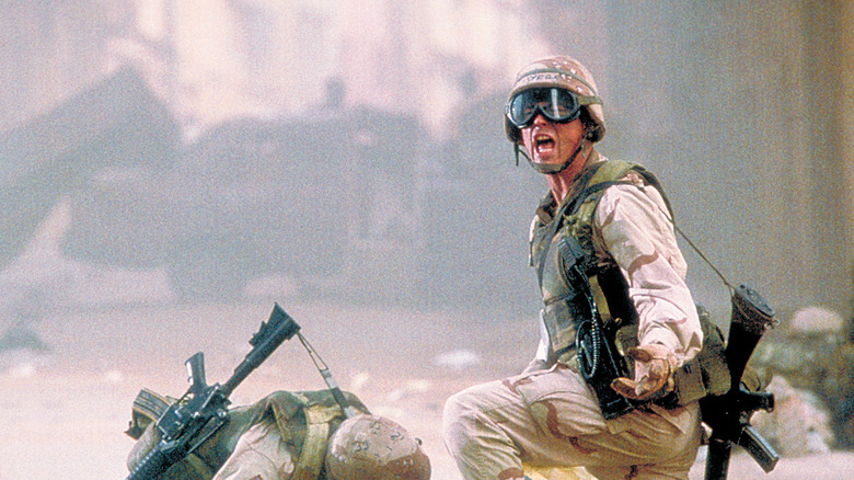 Two American soldiers crouch in a dusty street in Black Hawk Down