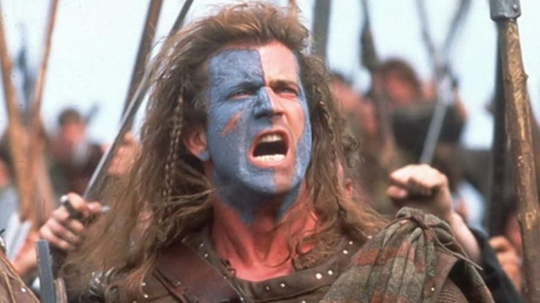 Mel Gibson as William Wallace shouts in war paint in Braveheart