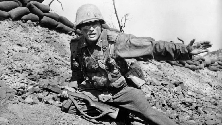 Gregory Peck as Lieutenant Clemons signals his men in Pork Chop Hill