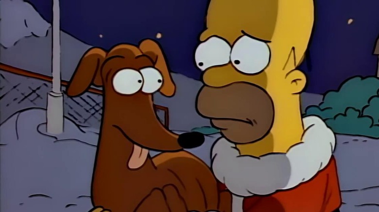 Homer holding Santa's Little Helper