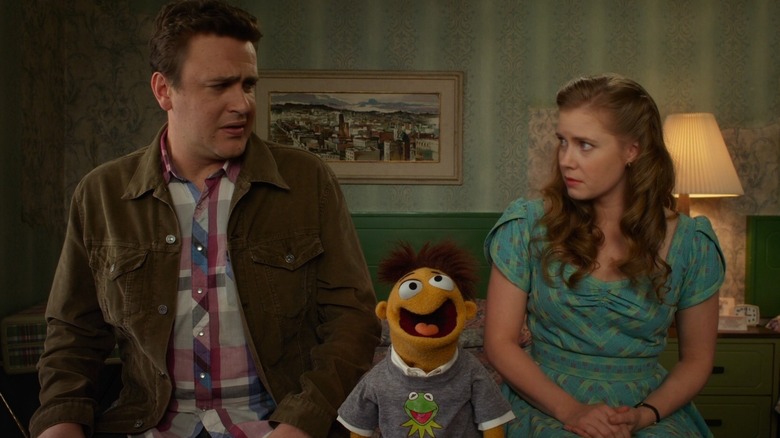 Jason Segal and Amy Adams with a muppet