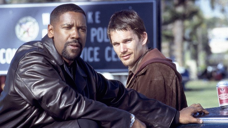 Denzel Washington and Ethan Hawke sitting on car