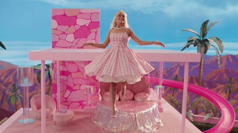 Barbie floats out of her house in Barbie