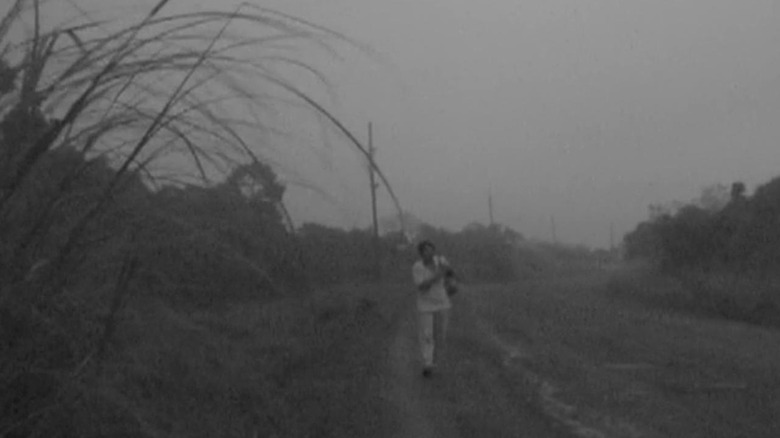 Heremias walking down an empty road in "Heremias, Book One: Legend of the Lizard Princess"