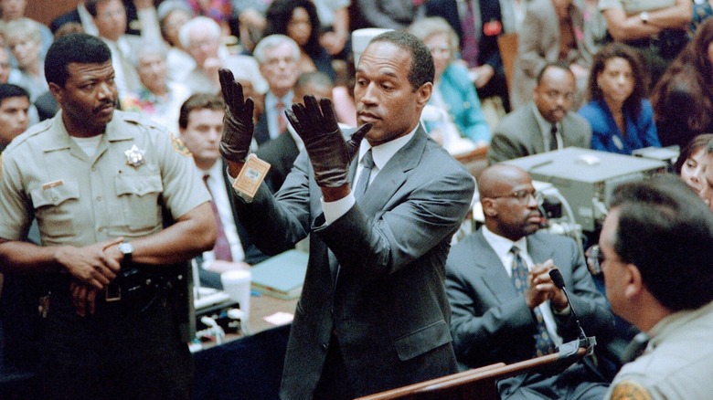 O.J. Simpson wearing a pair of gloves for a packed courtroom in O.J.: Made in America