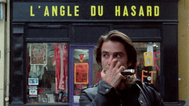 Colin plays a harmonica outside of a head shop in Paris in "Out 1 (Noli me tangere)"