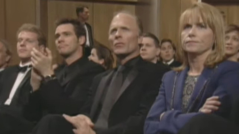 Ed Harris and Amy Madigan glaring during speech