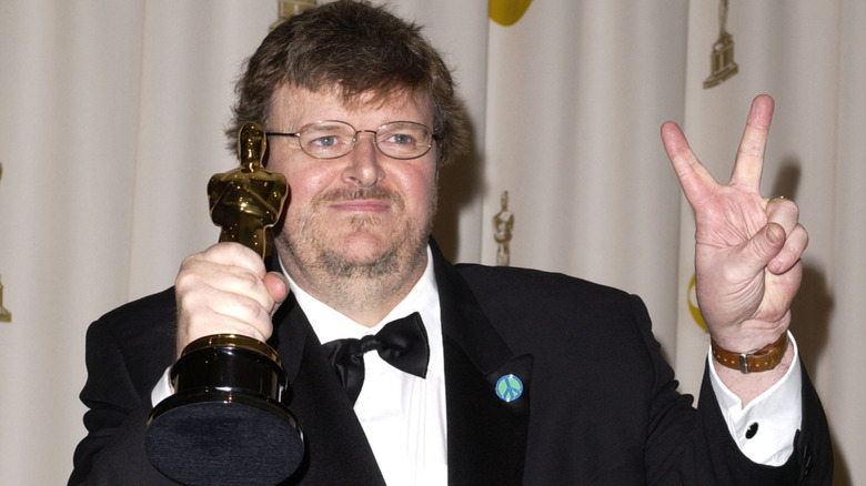 Michael Moore giving peace sign at Oscars