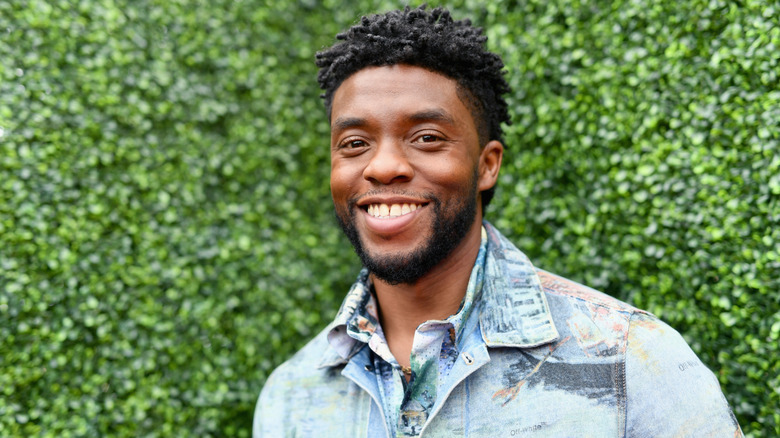 Chadwick Boseman in front of greenery