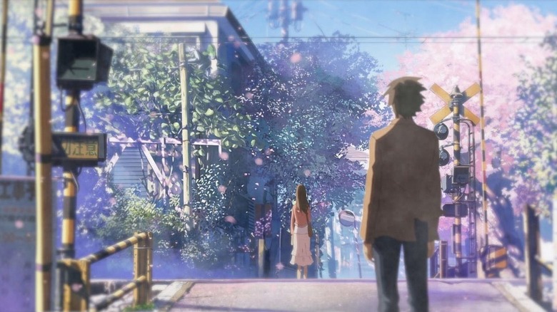 Takaki stares at Akari at a railroad crossing in 5 Centimeters per Second